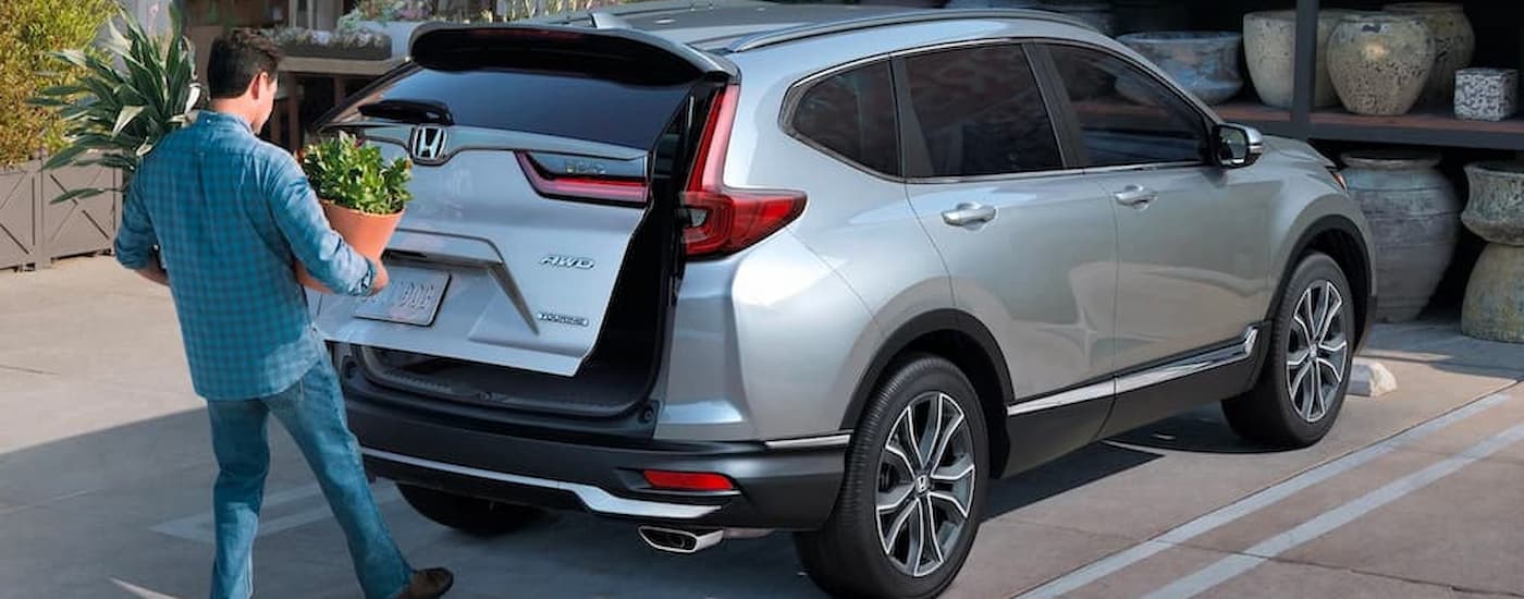 A silver 2022 Honda CR-V is shown from the rear as the lift-gate is opened.