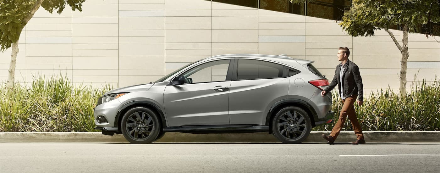 A silver 2022 Honda HR-V is shown from the side parked on a city street.