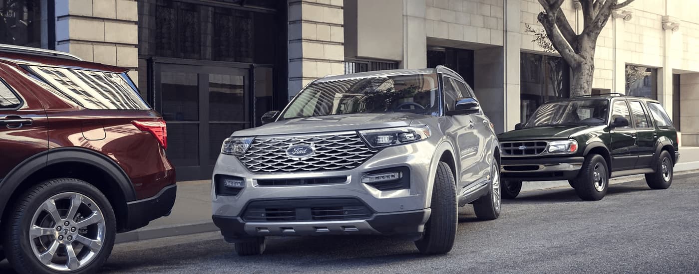 A silver 2023 Ford Explorer is shown from the front at an angle while parking.