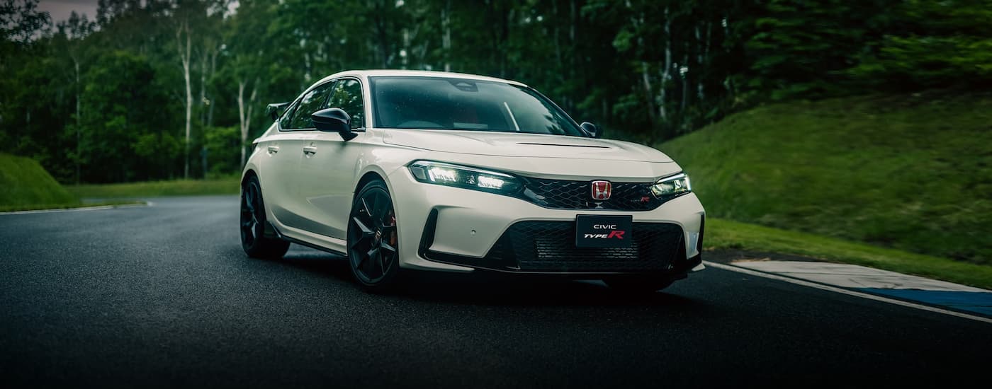 A white 2023 Honda Civic Type R is shown from the front on a racetrack.