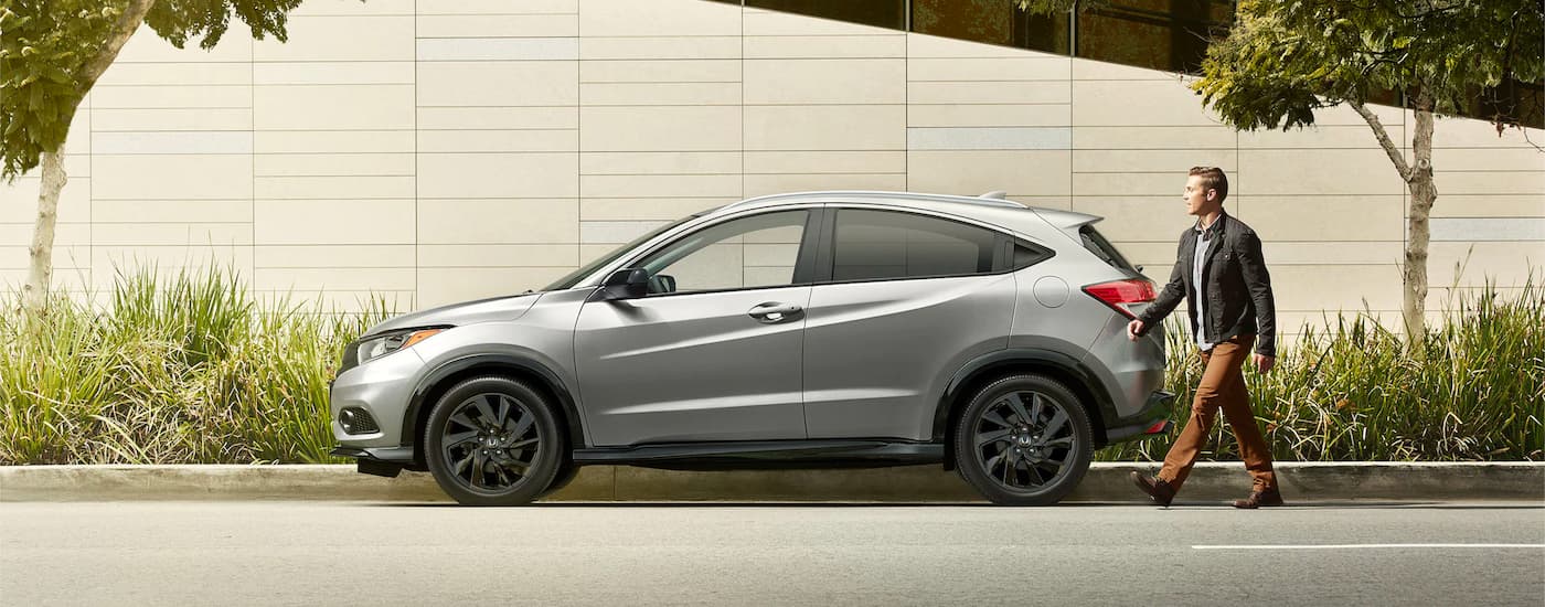 A person is shown approaching a grey 2022 Honda HR-V Sport after visiting a Honda dealer near you.
