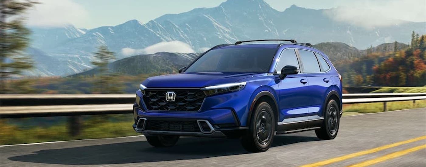 A blue 2022 Honda CR-V is shown from the side while driving.