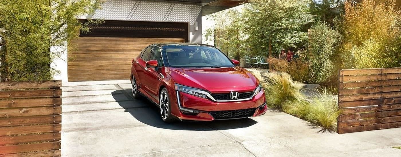 A red 2017 Honda Clarity Fuel Cell EX is shown parked on a driveway.