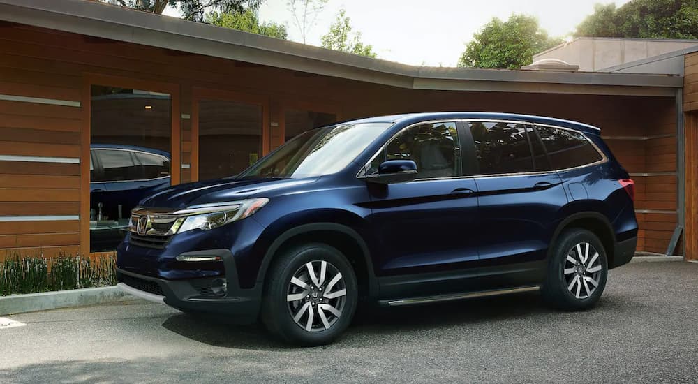 A blue 2021 Honda Pilot i shown from the front at an angle.