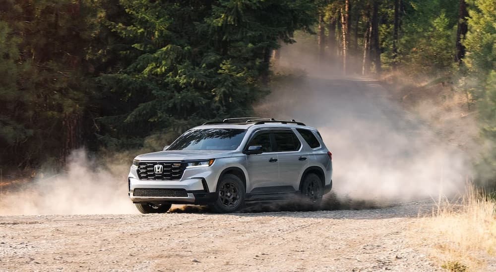 A grey 2024 Honda Pilot Trailsport is shown from the front at an angle.