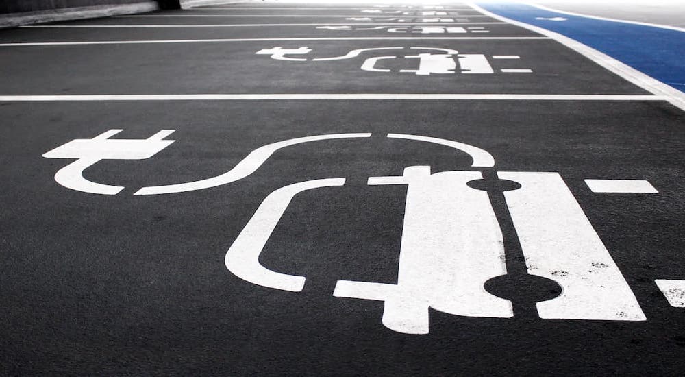 A row of charging EV parking spots are shown near a Odessa Honda dealer.