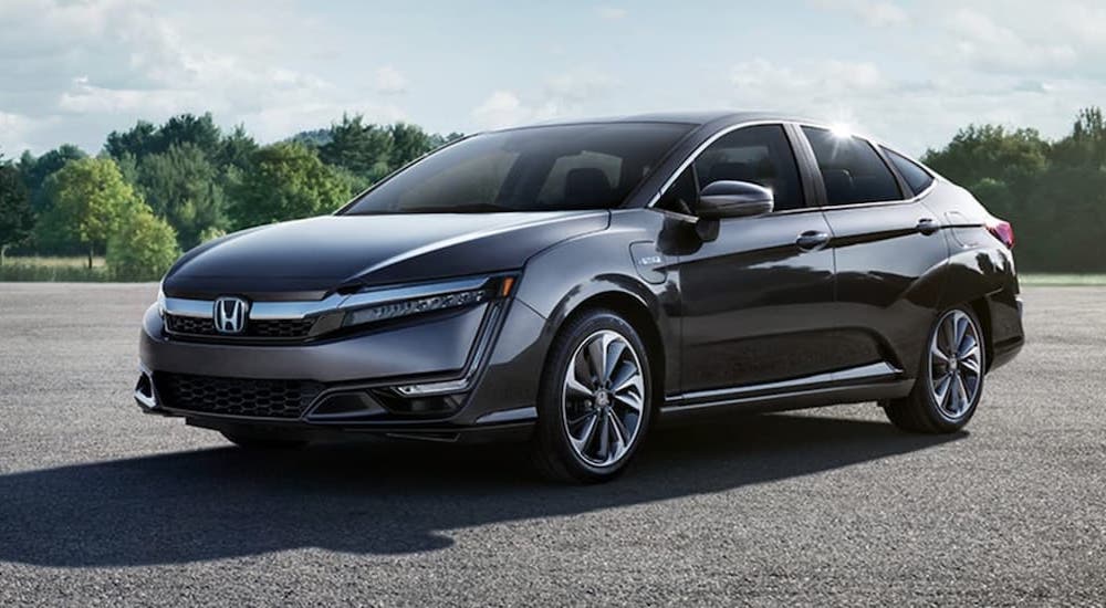 A grey 2021 Honda Clarity Plug-In is shown after leaving a used Honda dealership.
