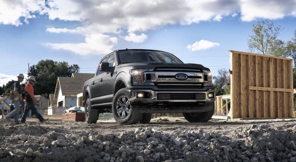 A grey 2018 Ford F-150 is shown parked at a construction site.
