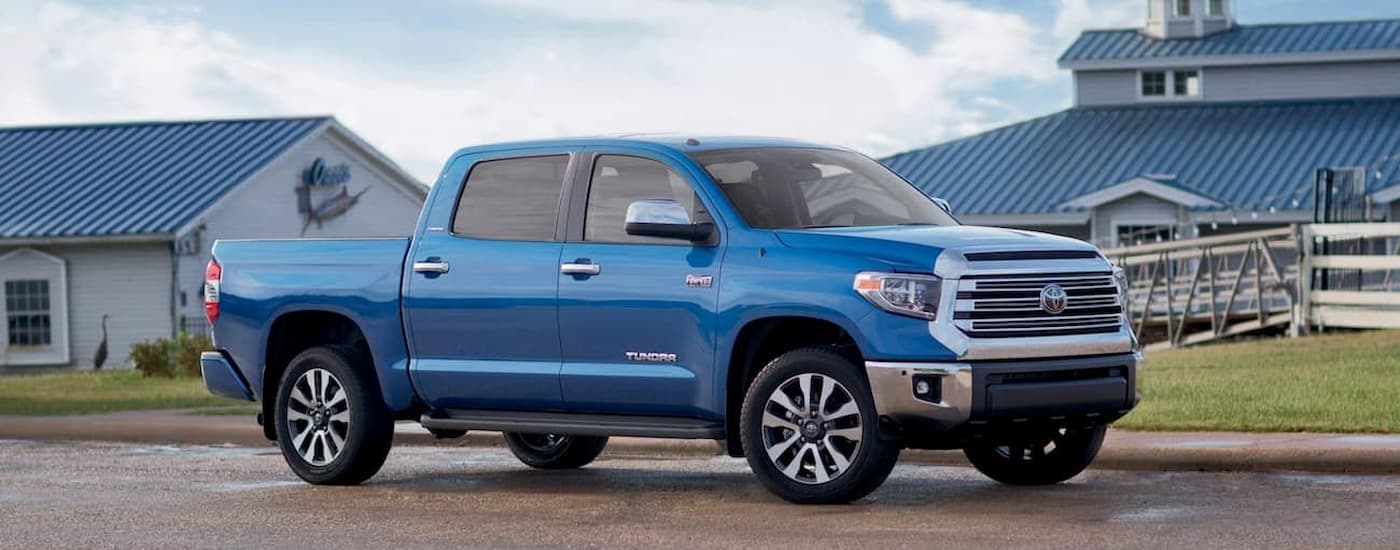 A blue 2018 Toyota Tundra is shown from the side parked on a farm.